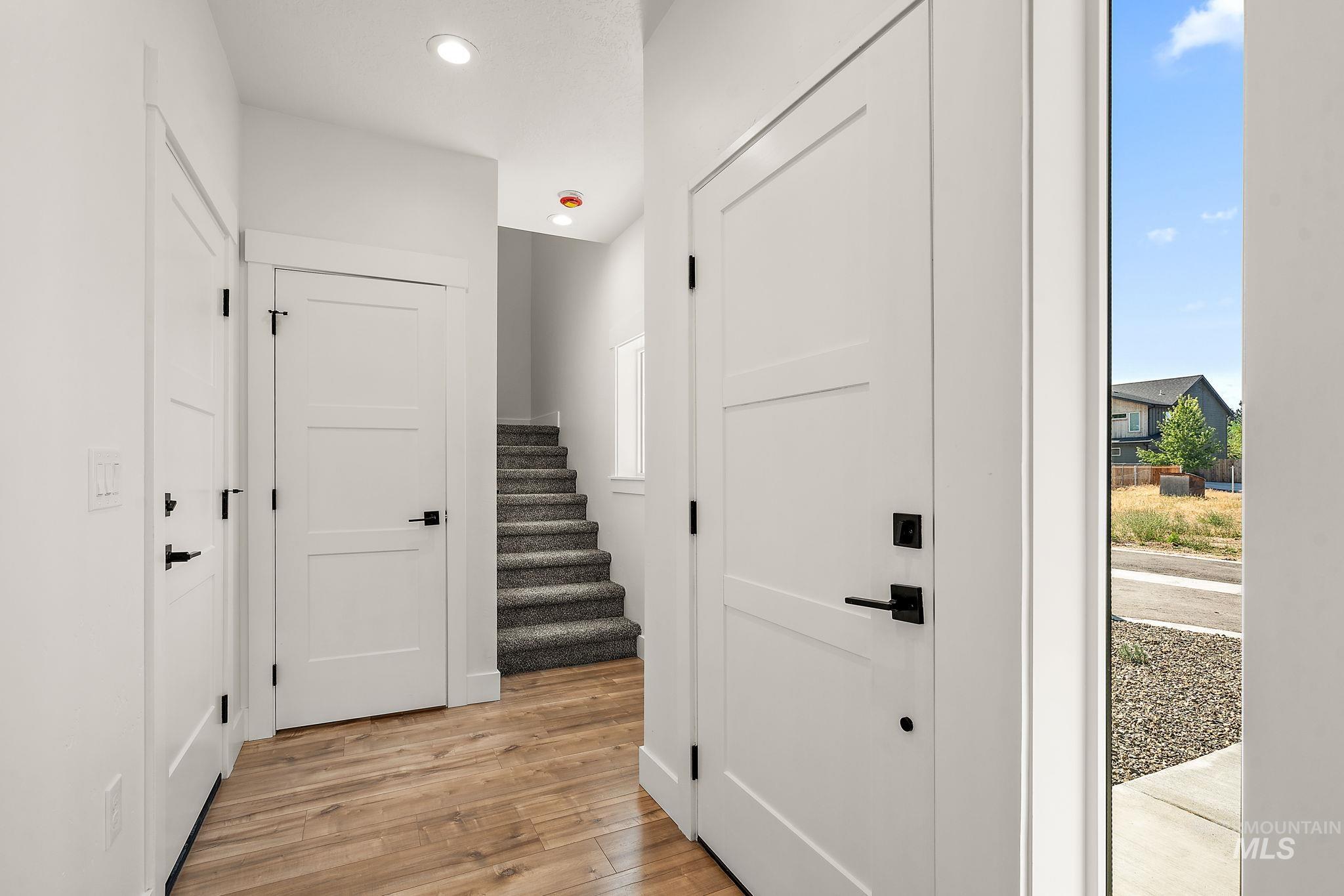 Entryway with light wood-style flooring, recessed lighting, and stairs