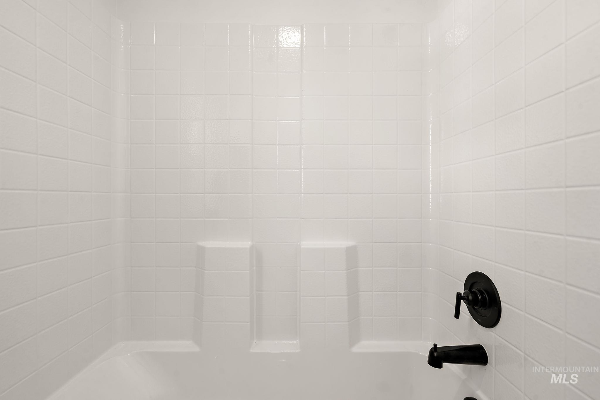Bathroom view of washtub / shower combination