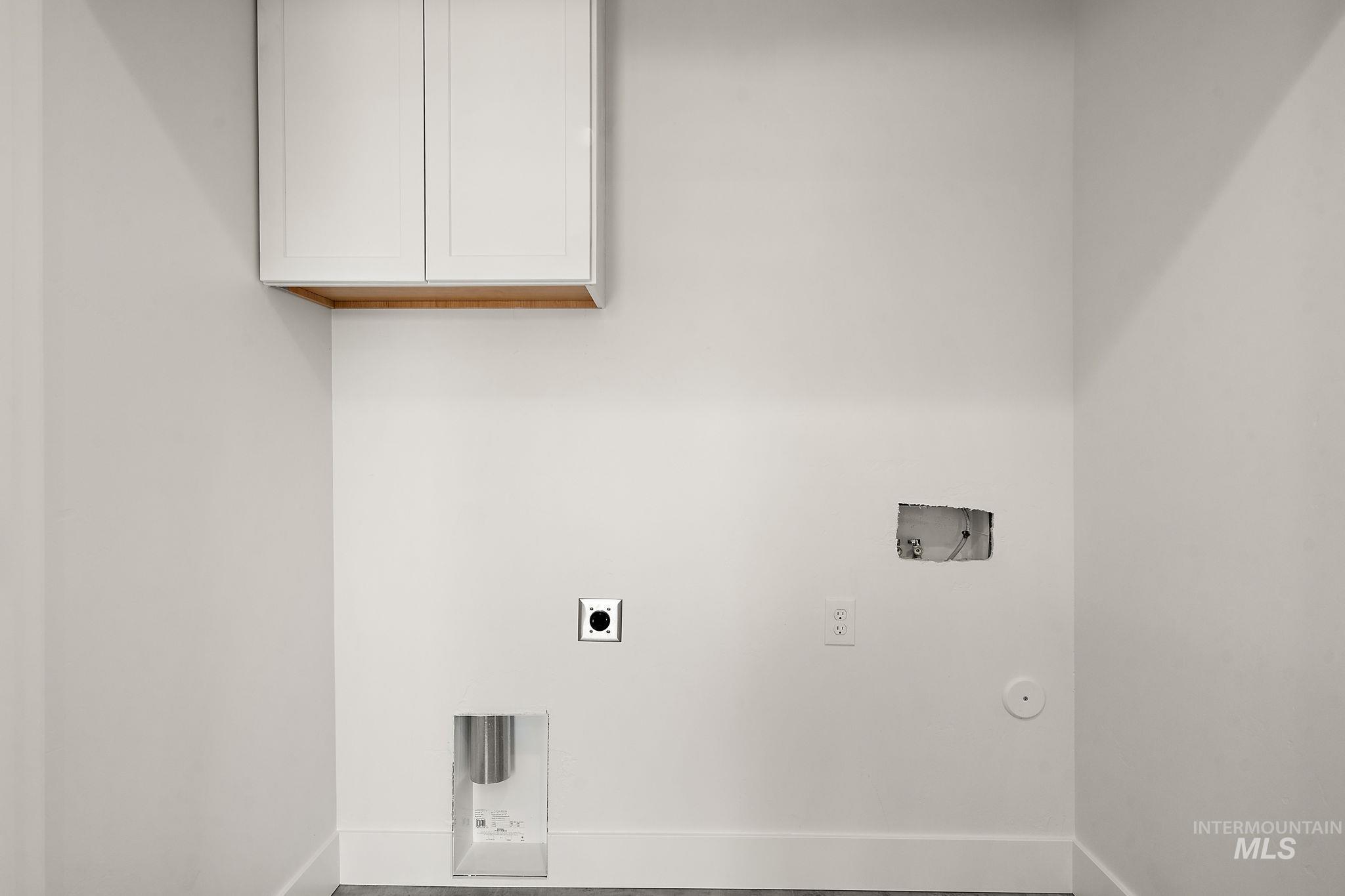 Laundry room with washer hookup, cabinet space, hookup for an electric dryer, and hookup for a gas dryer