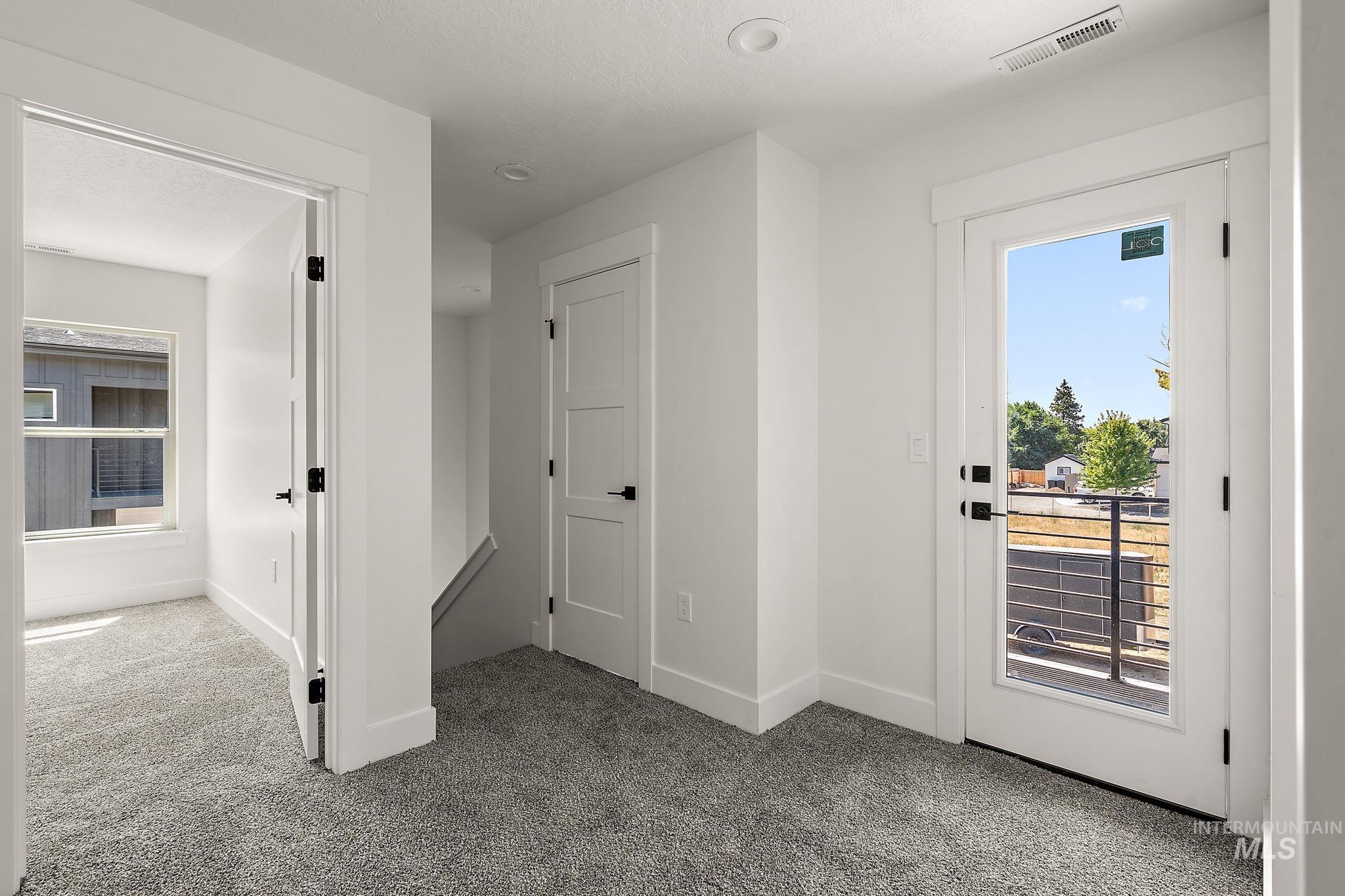Hallway featuring carpet and baseboards