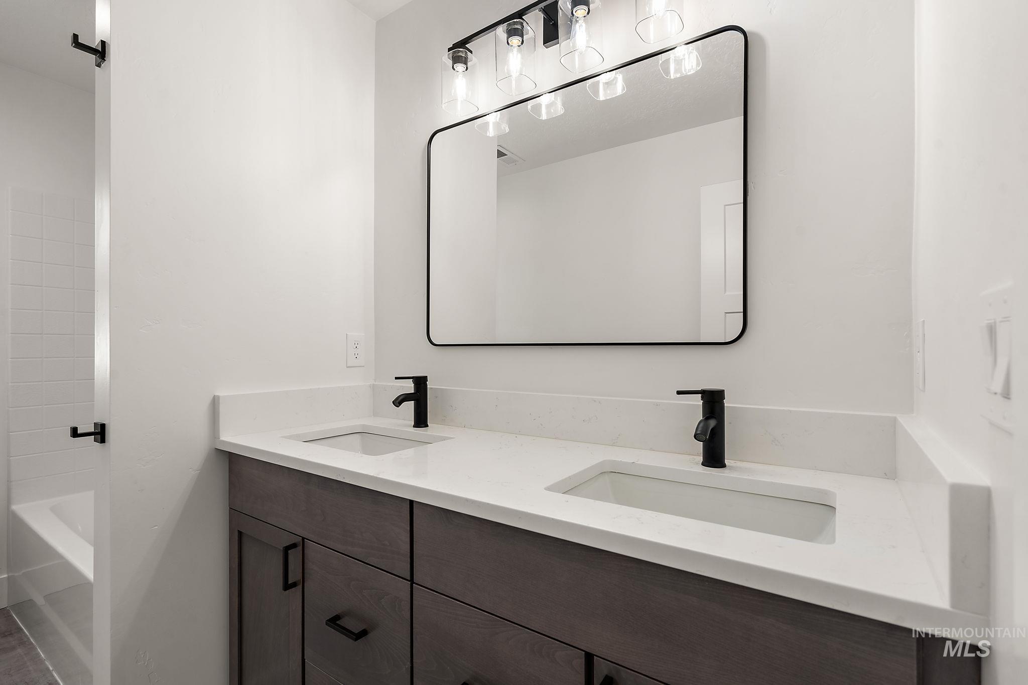 Bathroom with double vanity and  shower combination