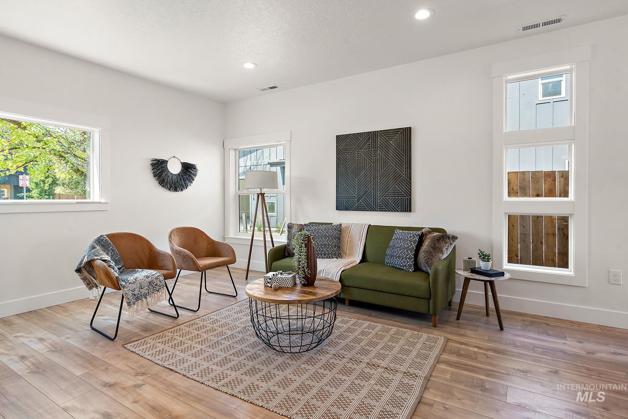 Sitting room featuring healthy amount of natural light, hardwood / wood-style flooring, and recessed lighting