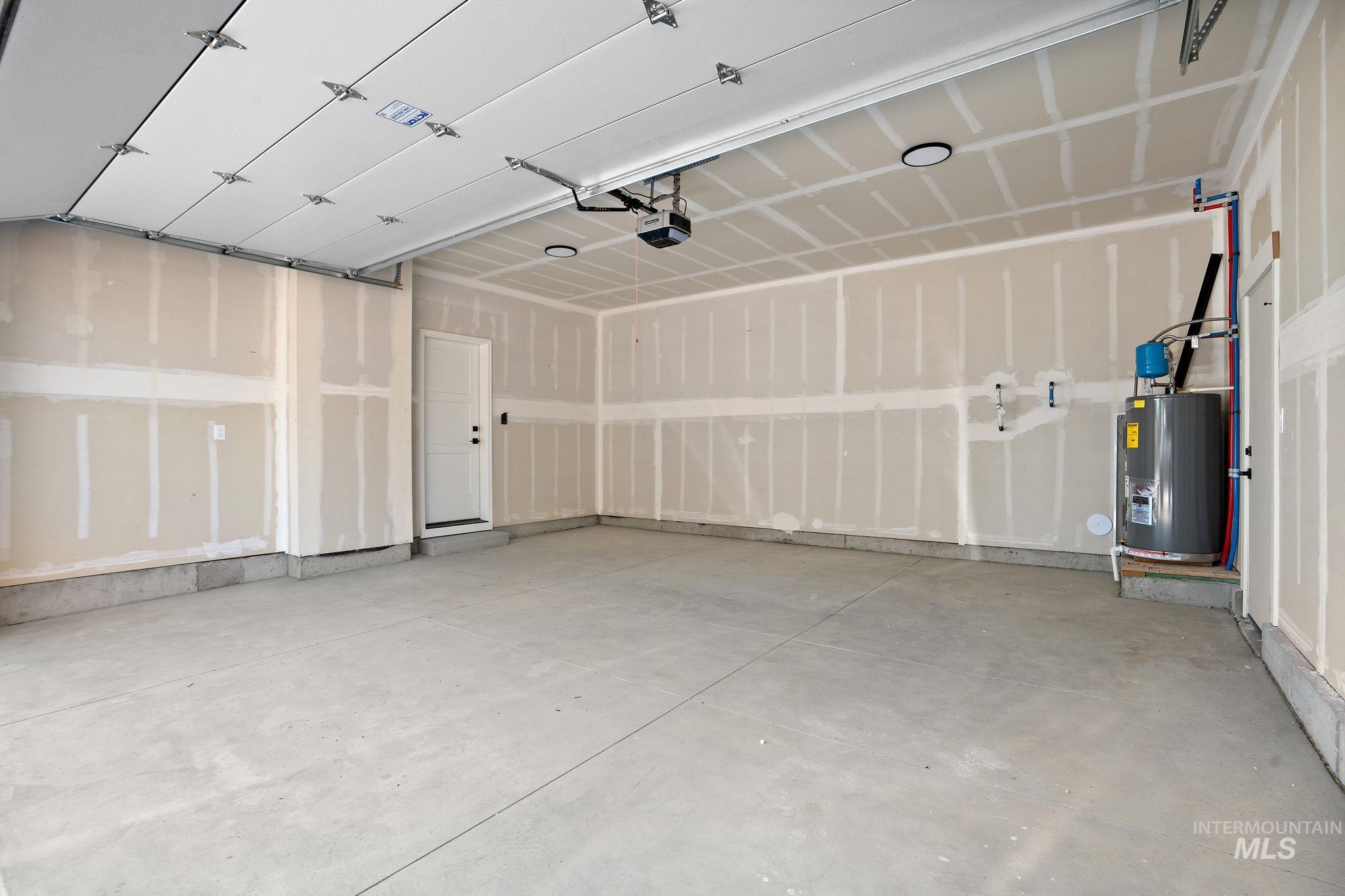 Garage with water heater and a garage door opener