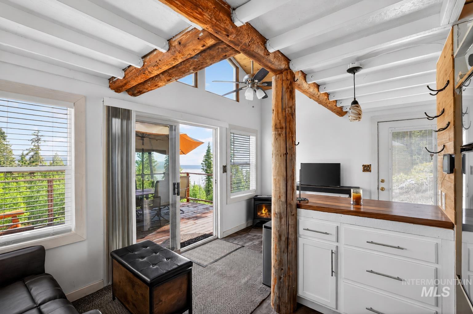 Exposed rustic wood beams and a white tongue-and-groove ceiling