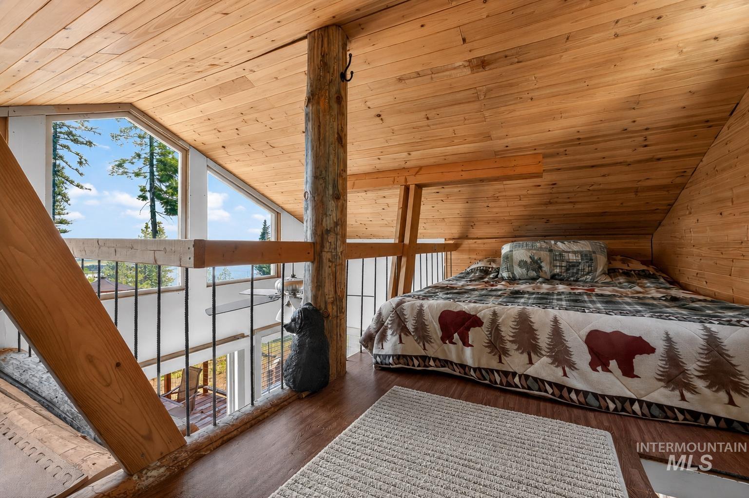 Wood-paneled ceiling and walls complement the natural wood flooring