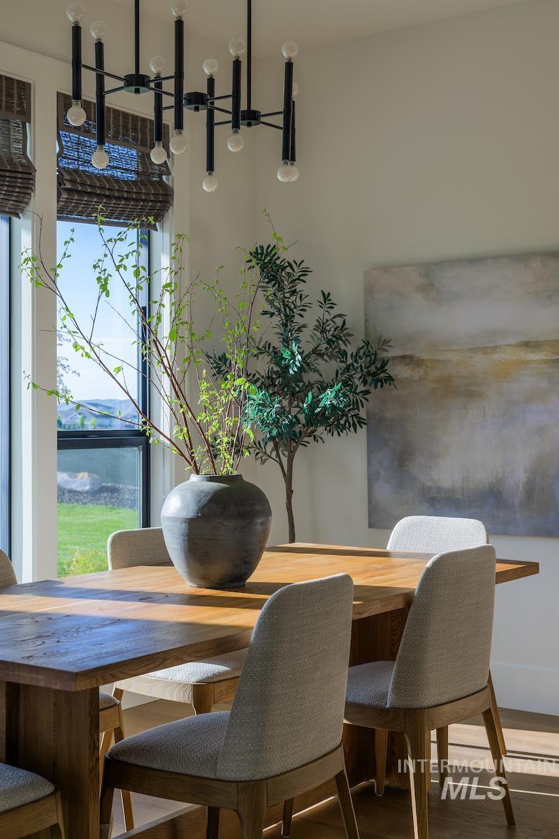 Dining space featuring wood finished floors and a chandelier