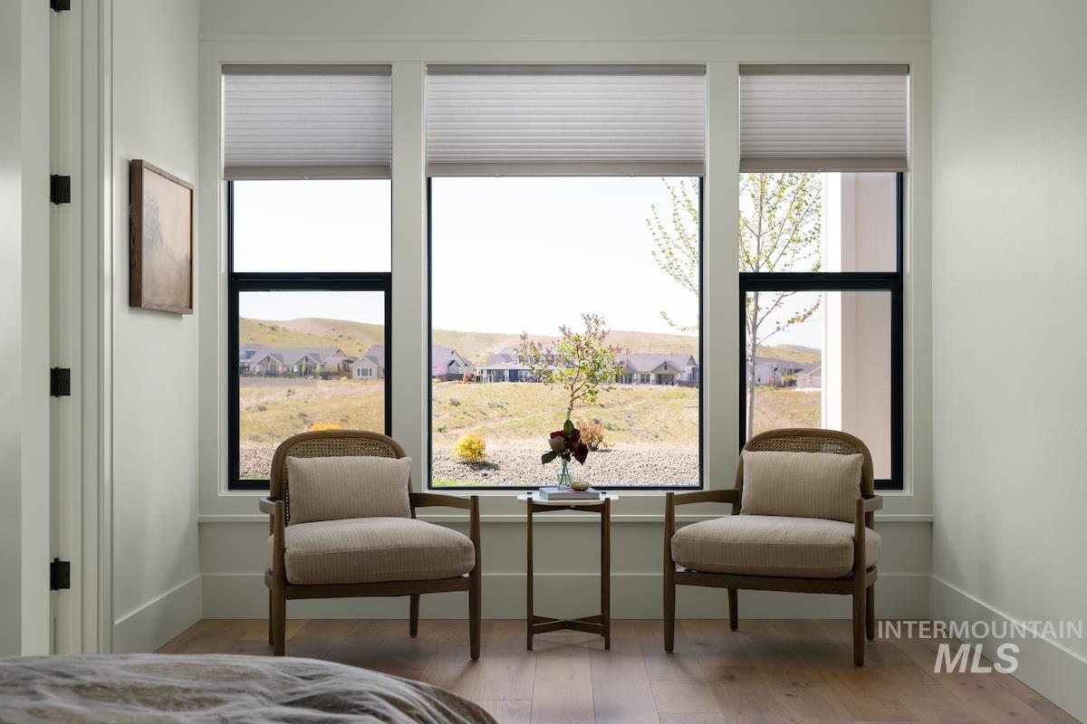 Bedroom featuring wood finished floors and multiple windows