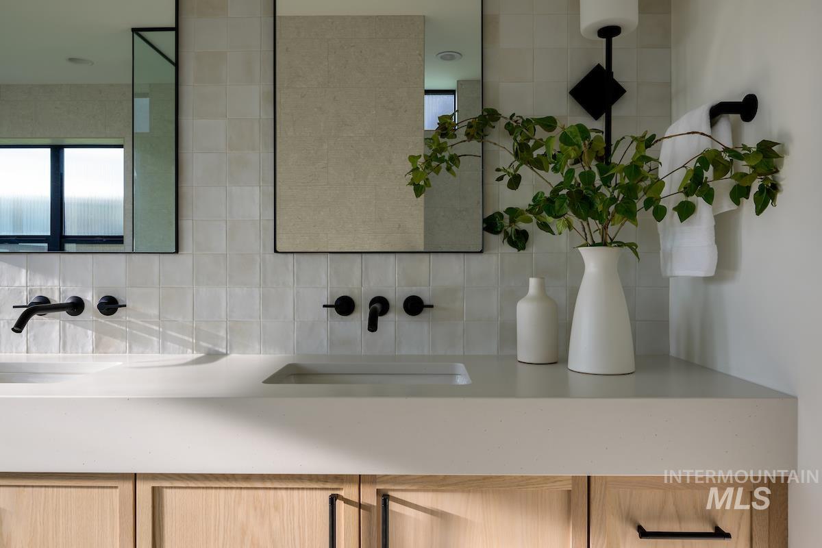 Bathroom with double vanity and decorative backsplash