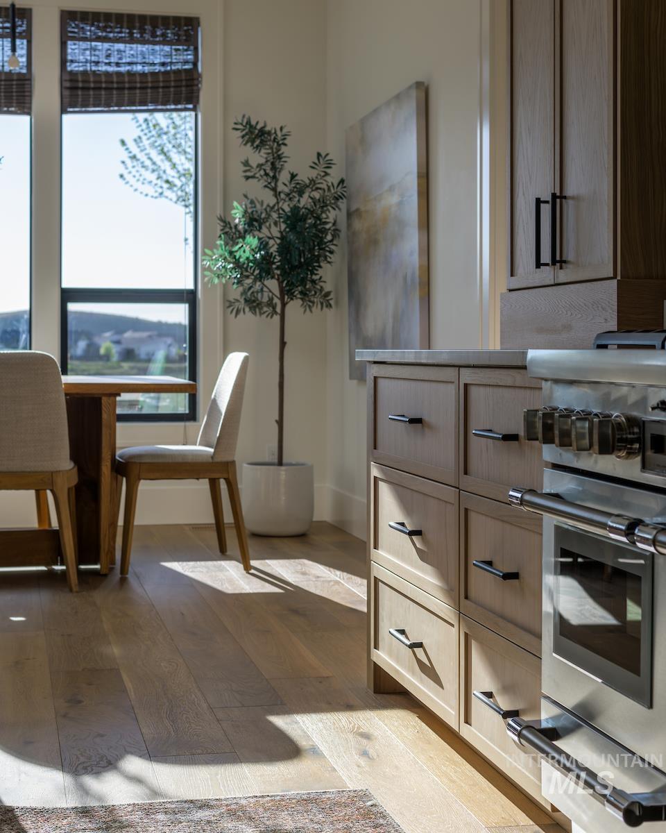 Dining room with dark wood finished floors and baseboards