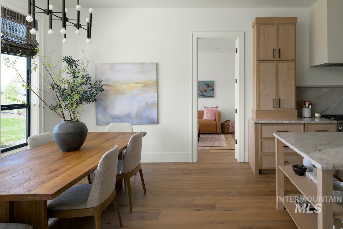 Dining area featuring wood finished floors and a chandelier