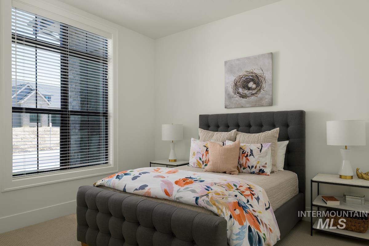 Carpeted bedroom with multiple windows