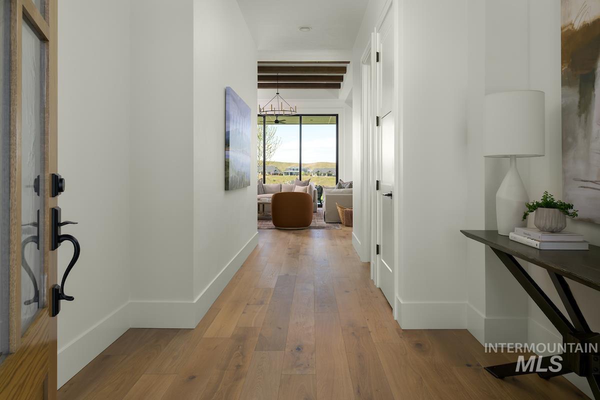 Hallway featuring hardwood / wood-style floors and baseboards
