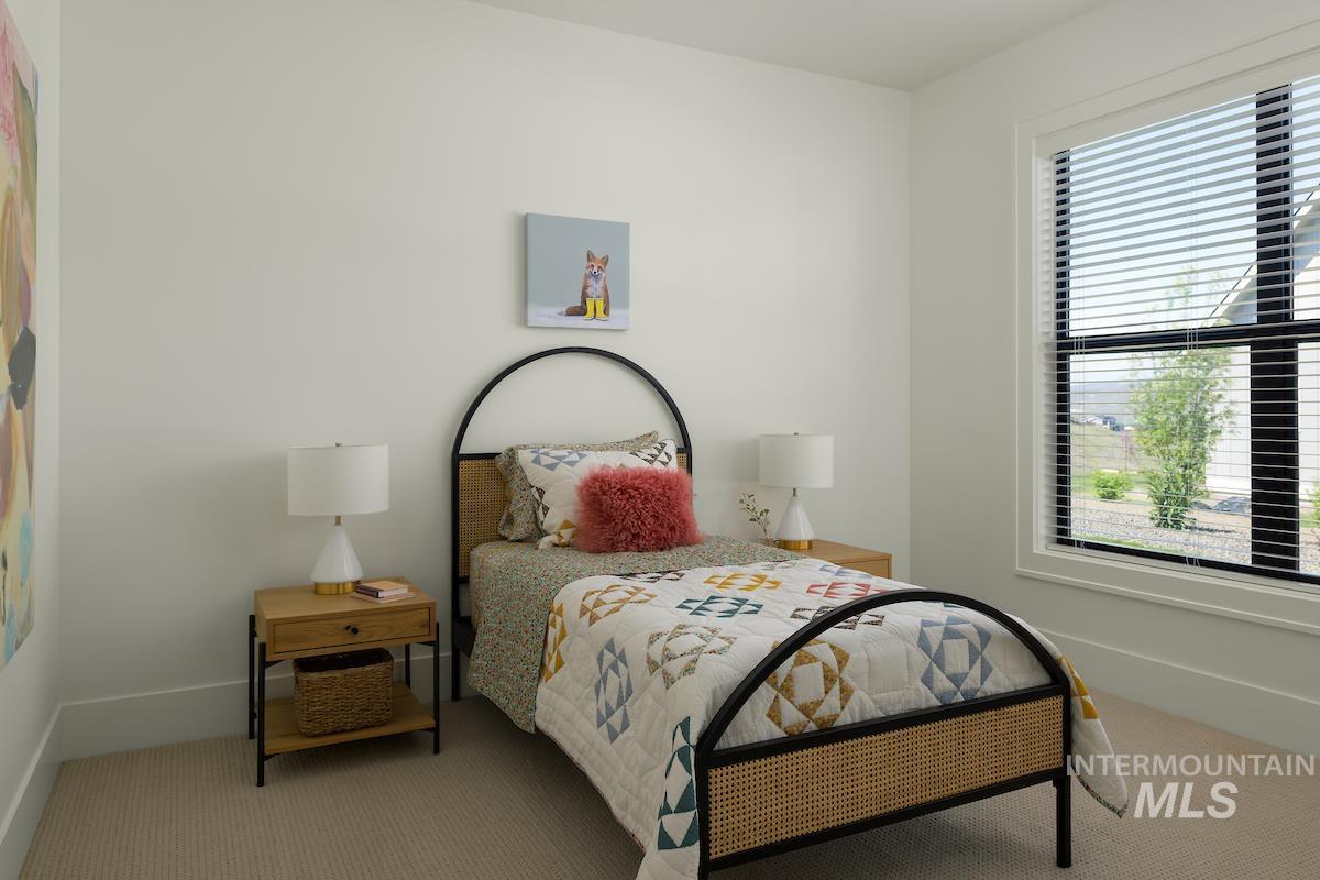 Carpeted bedroom with baseboards