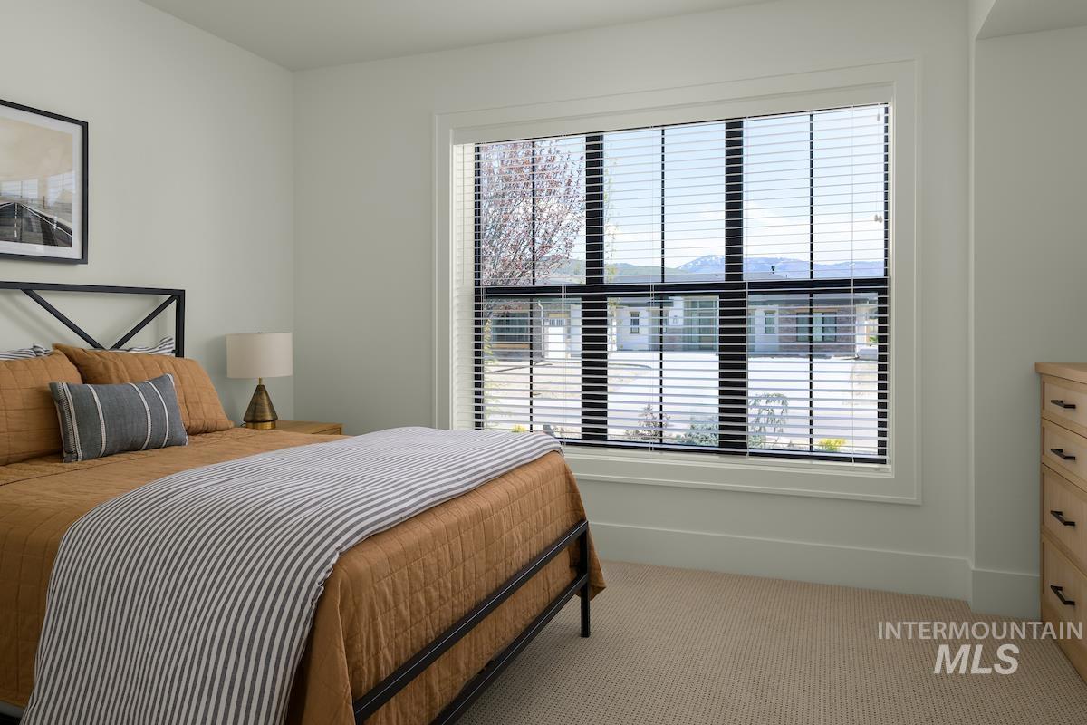 Carpeted bedroom with a mountain view