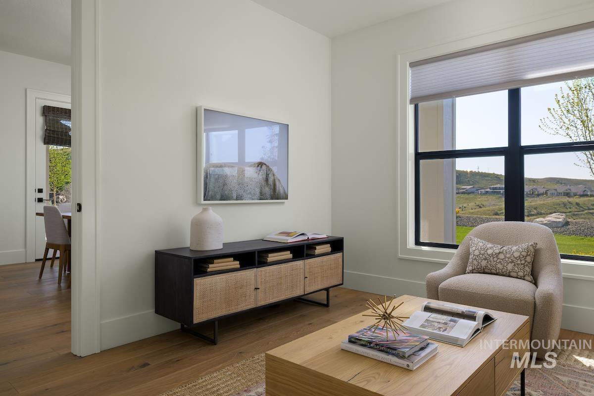 Living area with healthy amount of natural light and wood finished floors