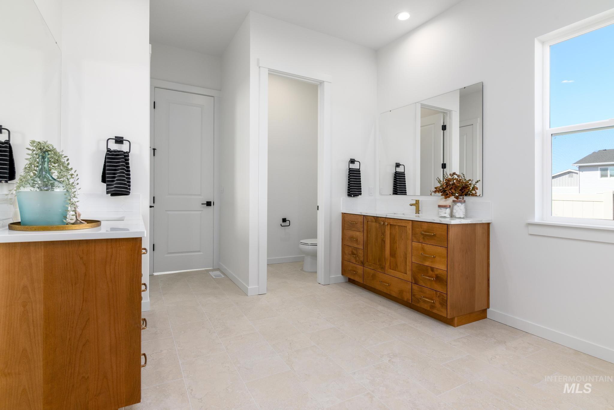 Full bathroom featuring vanity and baseboards