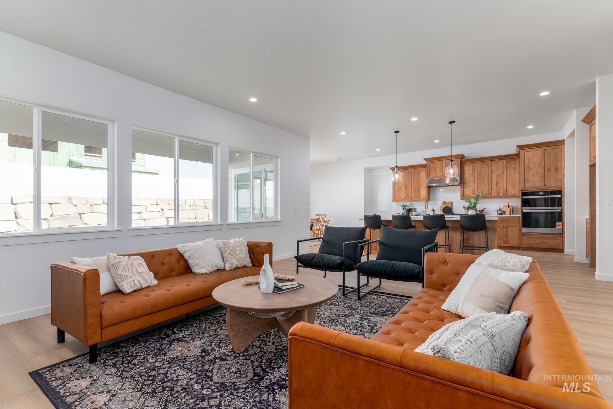 Living room featuring light wood finished floors and recessed lighting