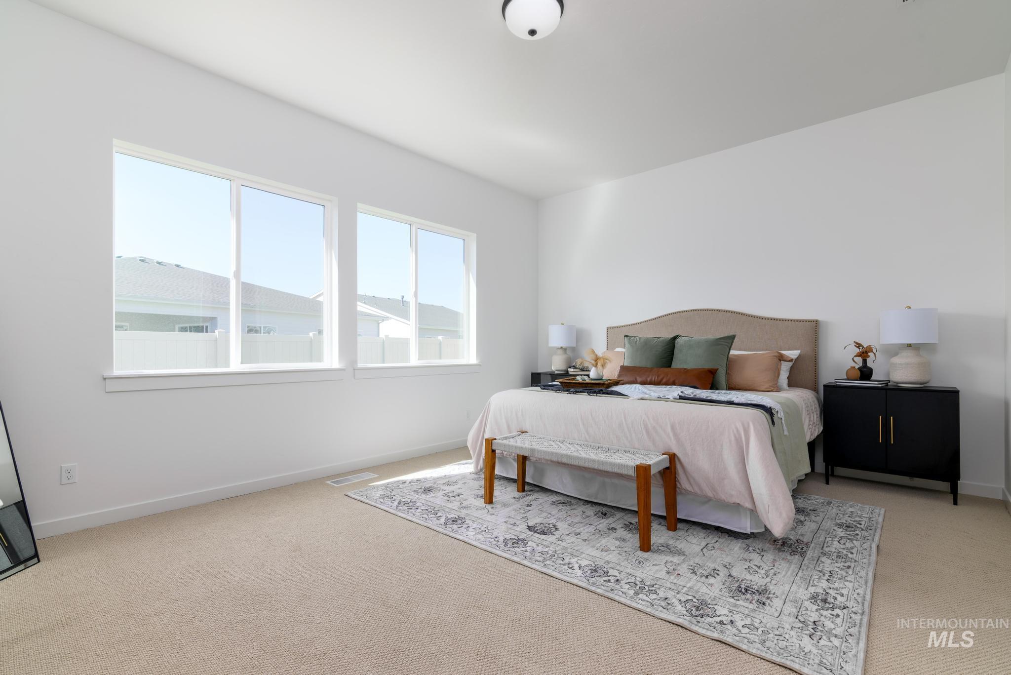 Bedroom with light colored carpet