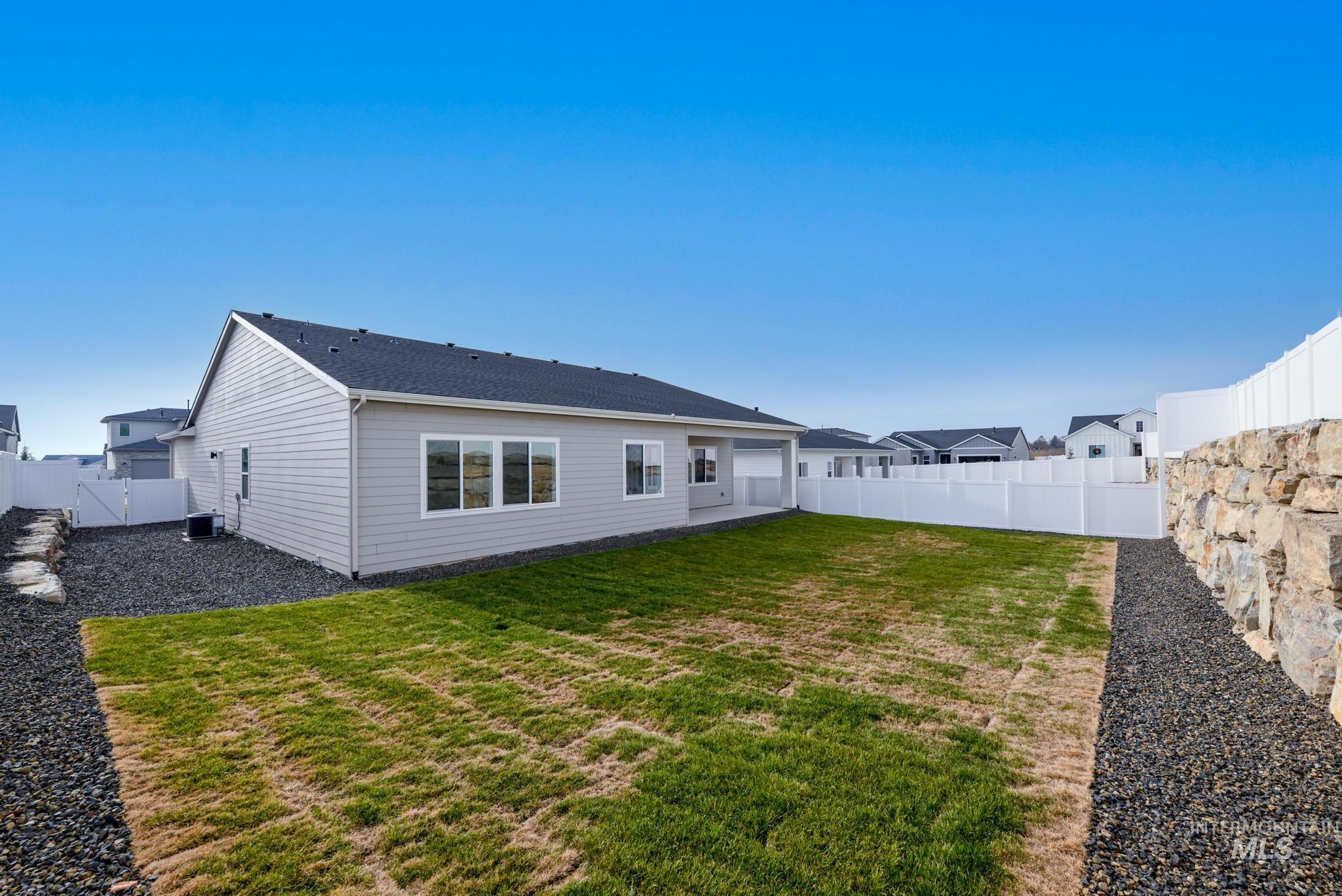 Rear view of property with a fenced backyard, a patio area, and a gate