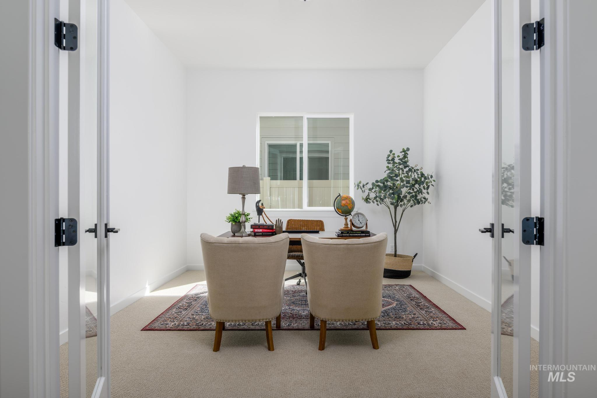 Home office featuring french doors and light carpet