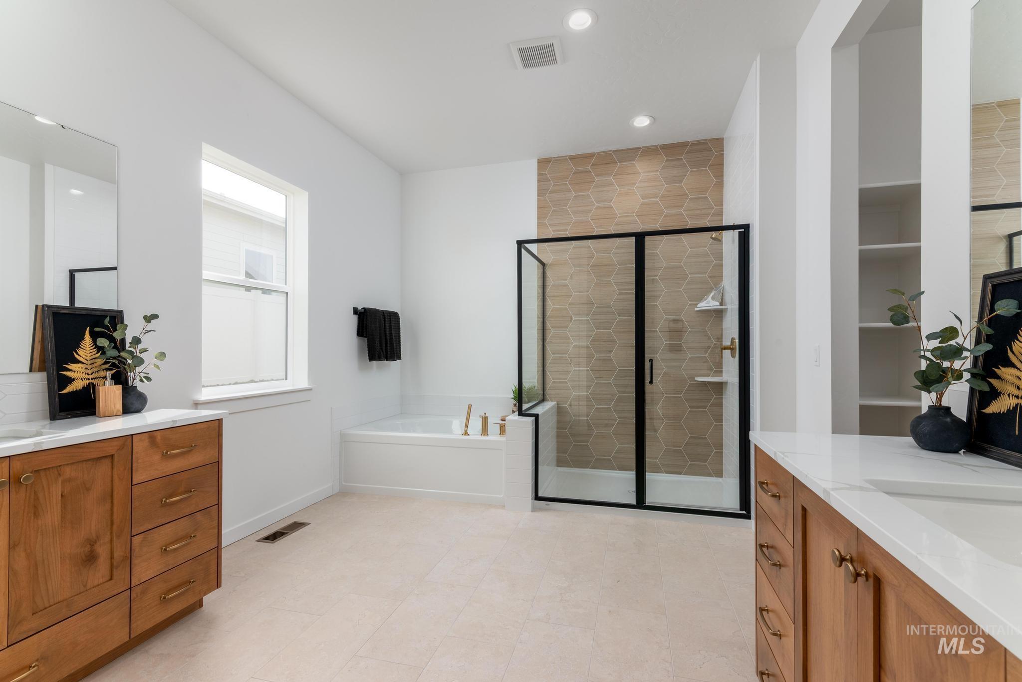 Bathroom featuring a bath, a shower stall, vanity, and recessed lighting