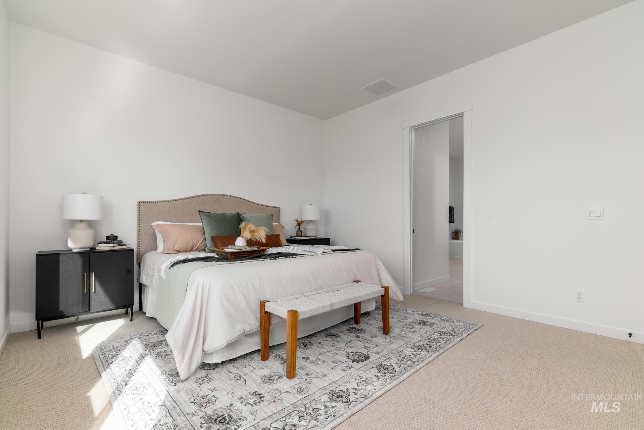 Carpeted bedroom featuring baseboards