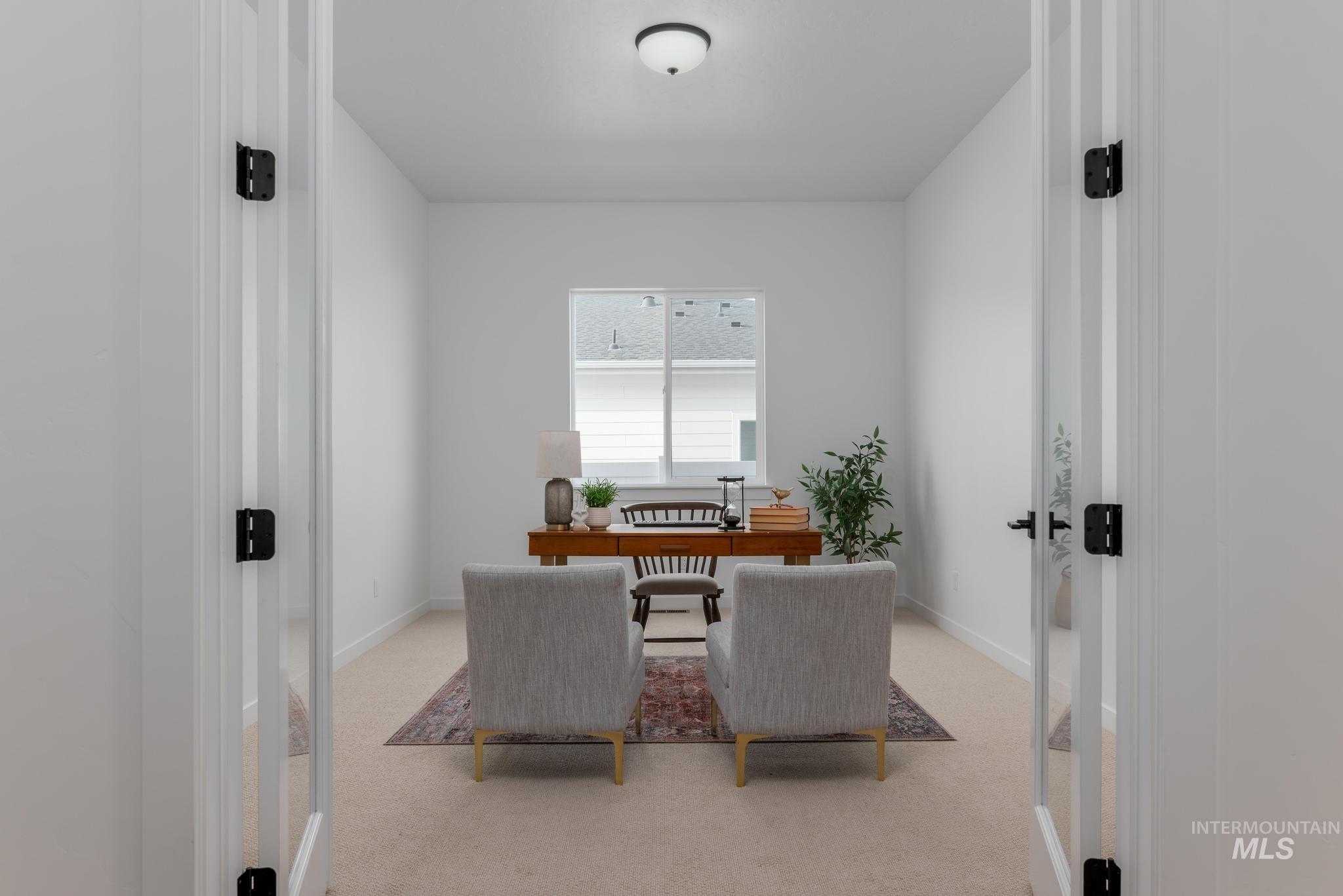 Dining space with a desk, light carpet, and french doors