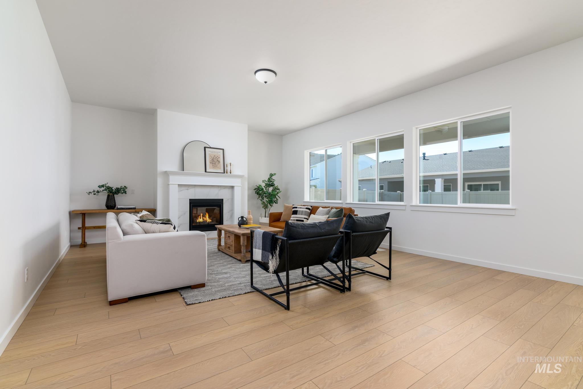 Living area with a fireplace and light wood-style flooring