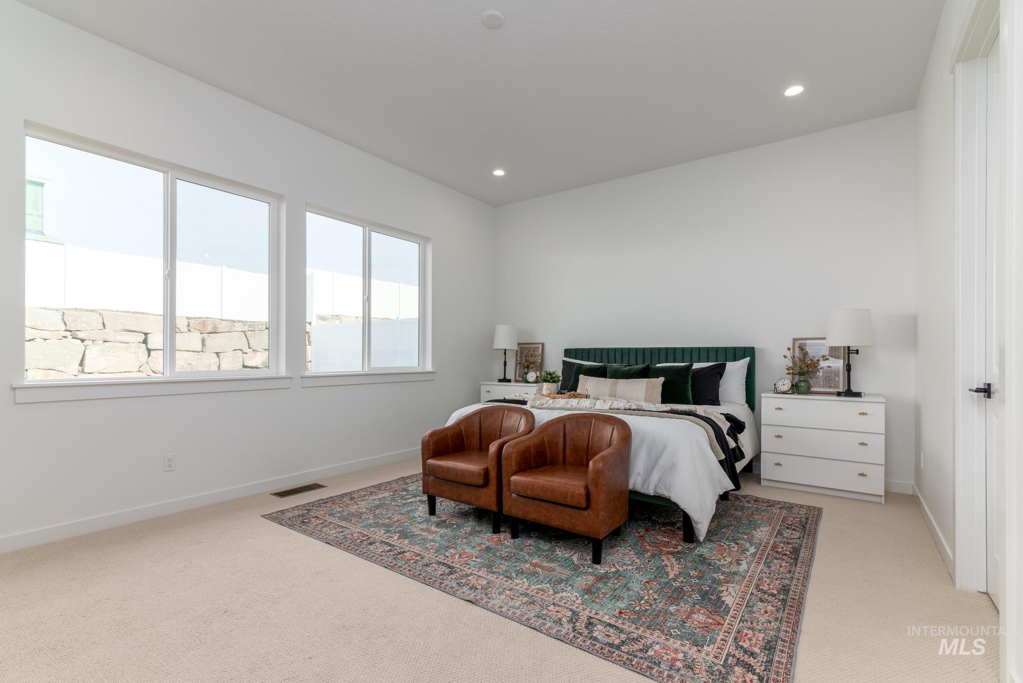 Bedroom with light carpet and recessed lighting