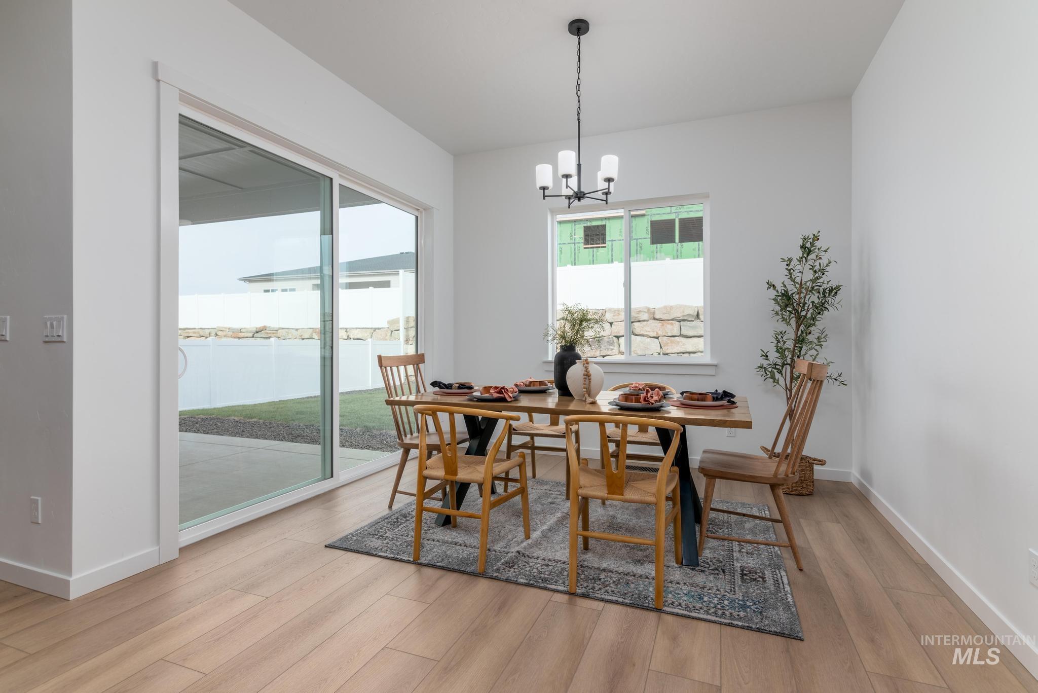 Dining space featuring a chandelier and light wood-type flooring