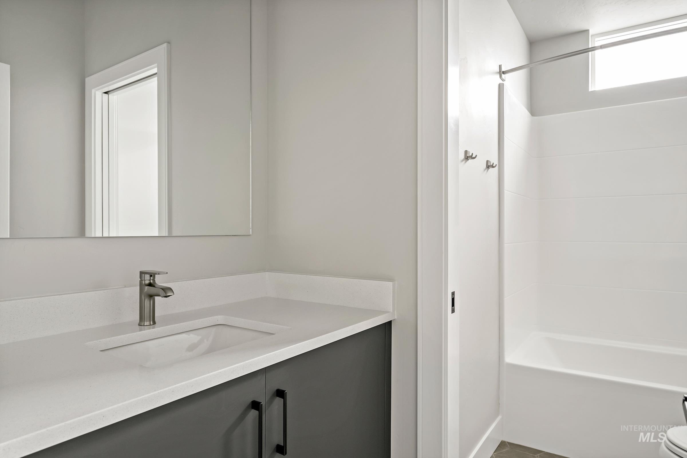 Bathroom featuring vanity and bathtub / shower combination