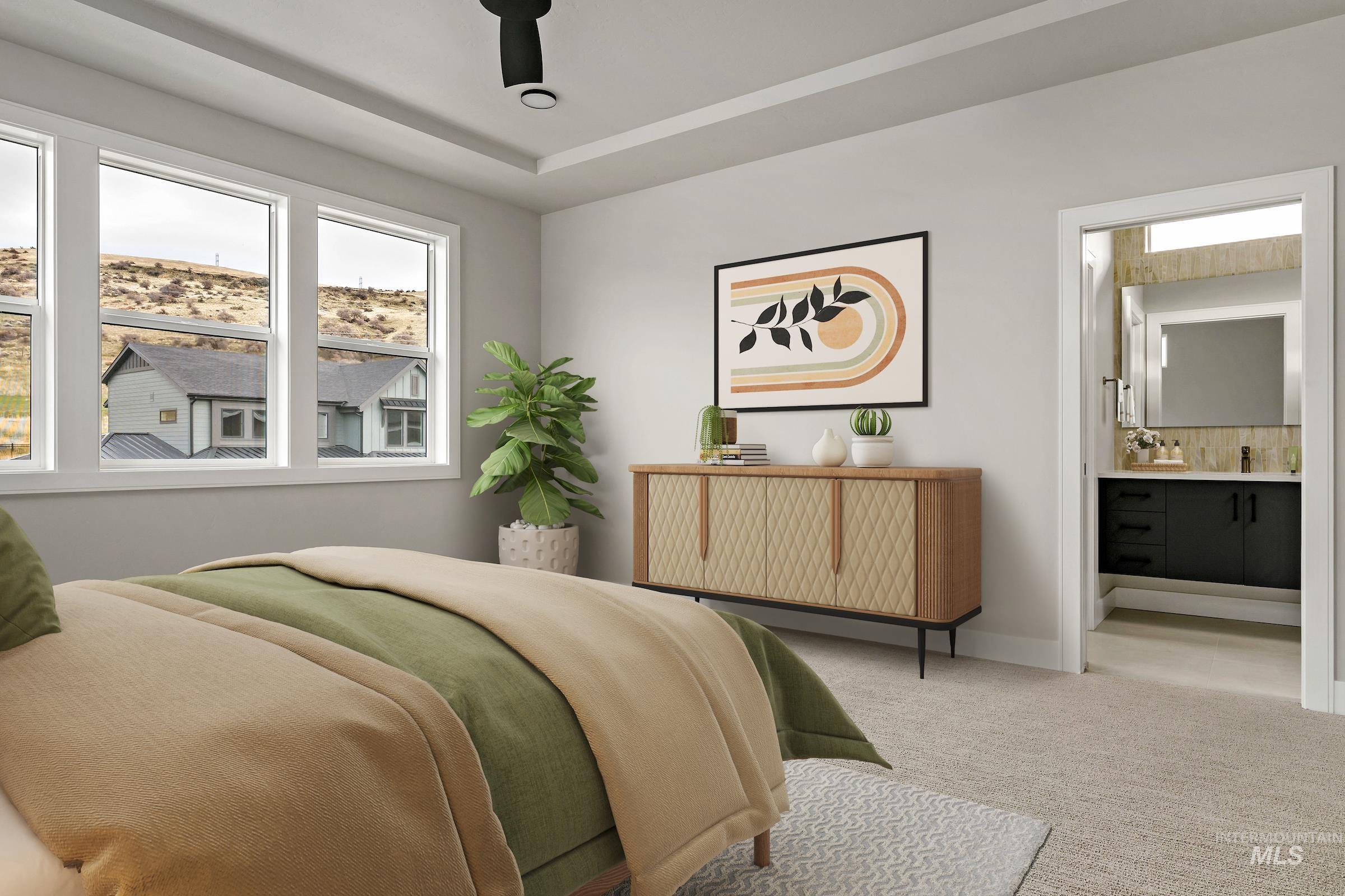 Bedroom featuring carpet, ensuite bath, and ceiling fan