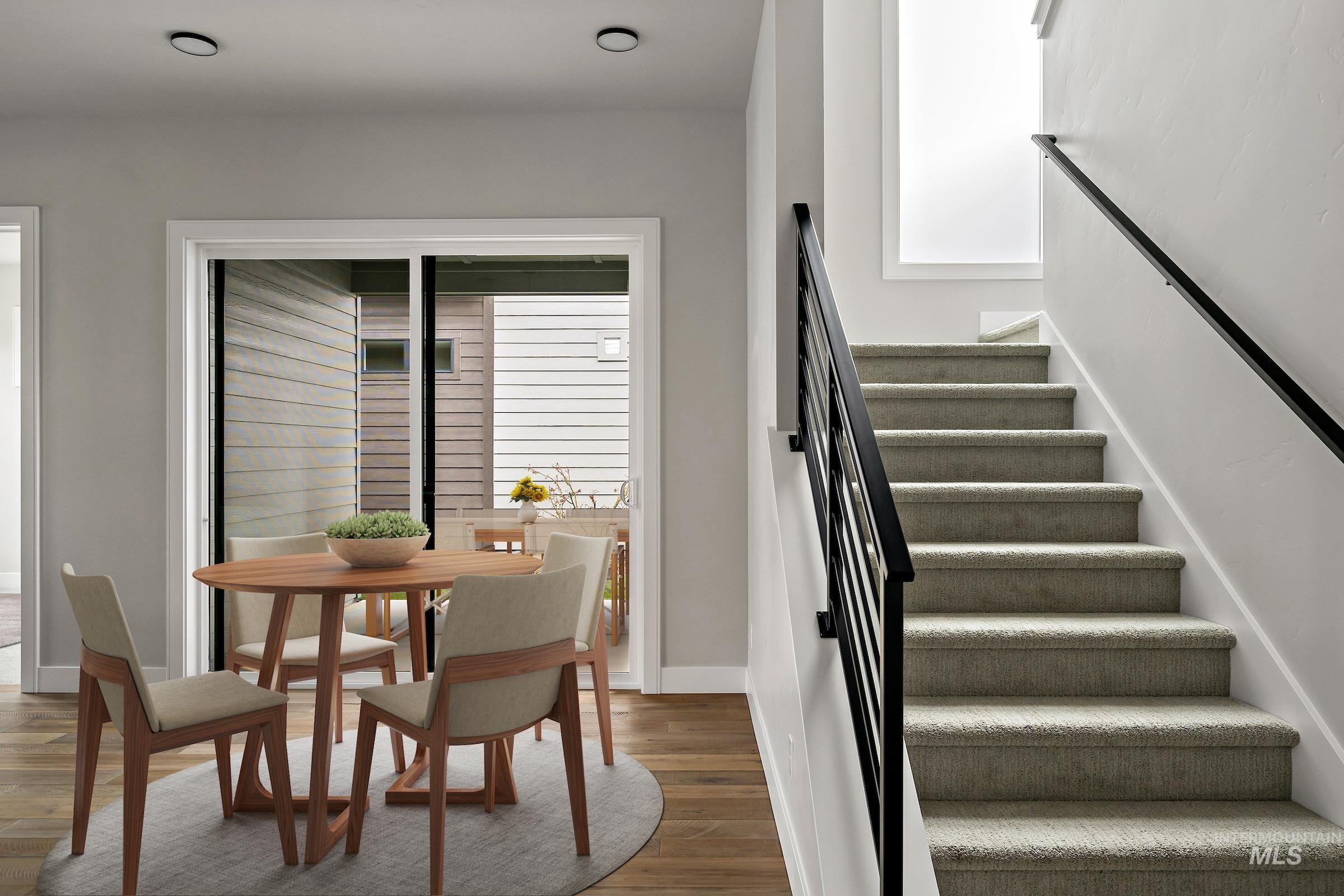 Stairway with wood finished floors and baseboards