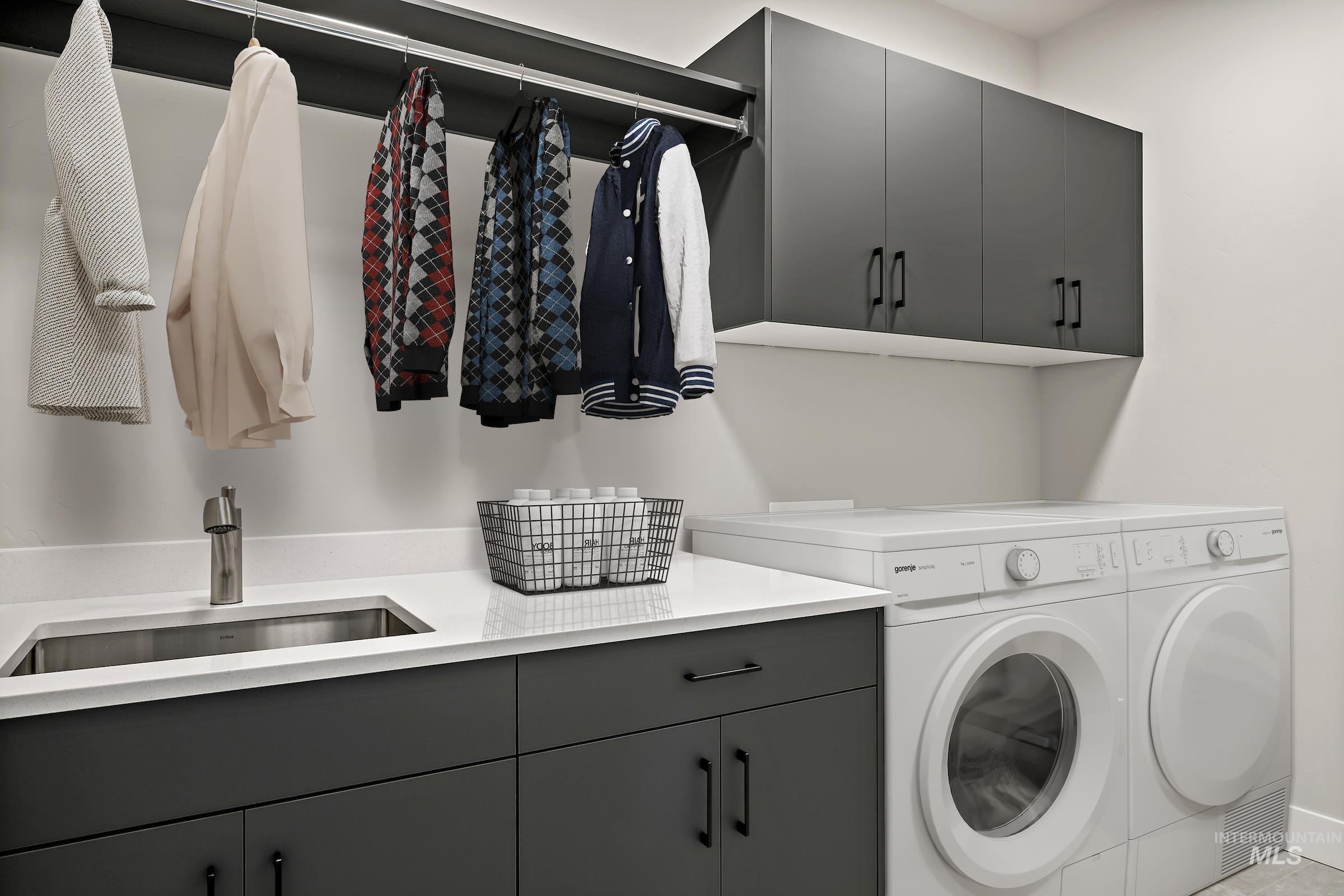 Laundry area featuring separate washer and dryer and cabinet space