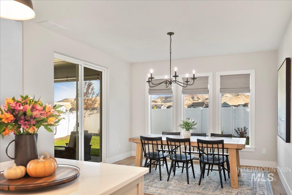 Dining space featuring light wood-type flooring and suspended lighting