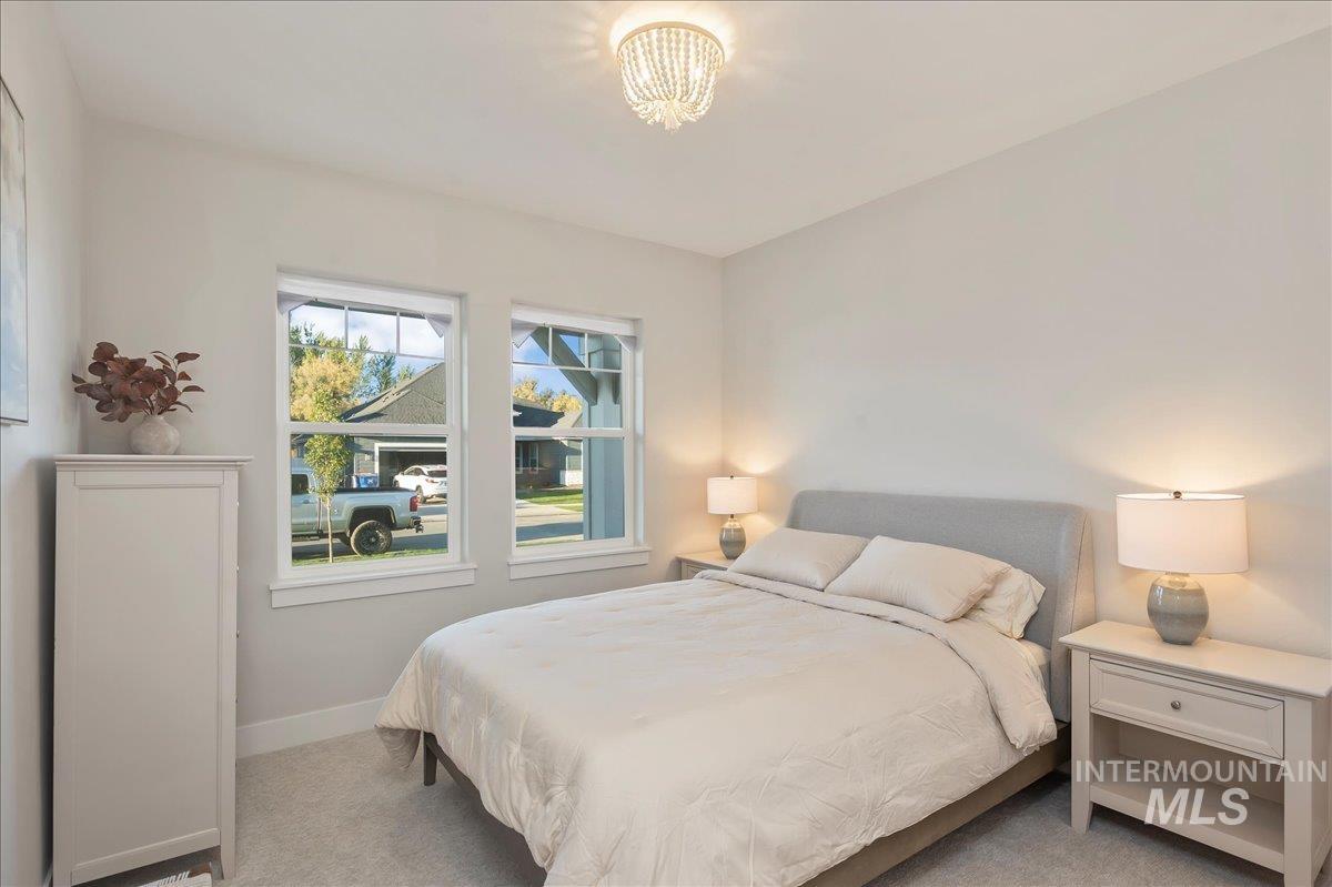 Carpeted bedroom with baseboards