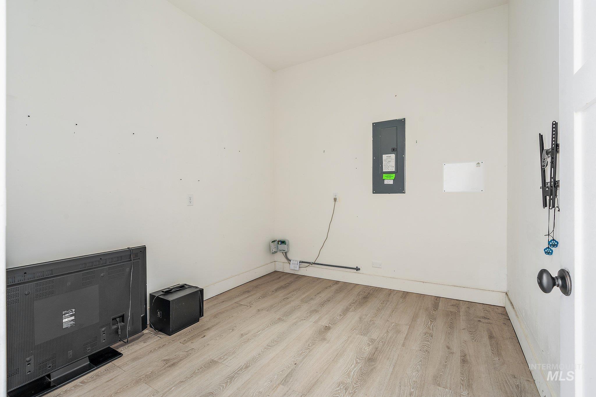 Washroom featuring light wood-type flooring and electric panel