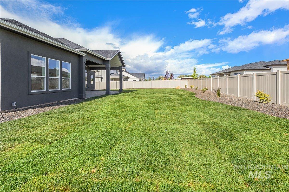 Fenced backyard with a patio