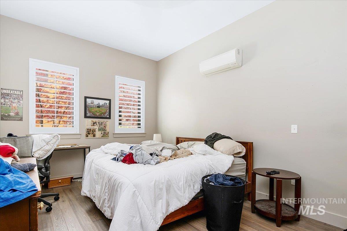 Bedroom featuring wood finished floors and a desk