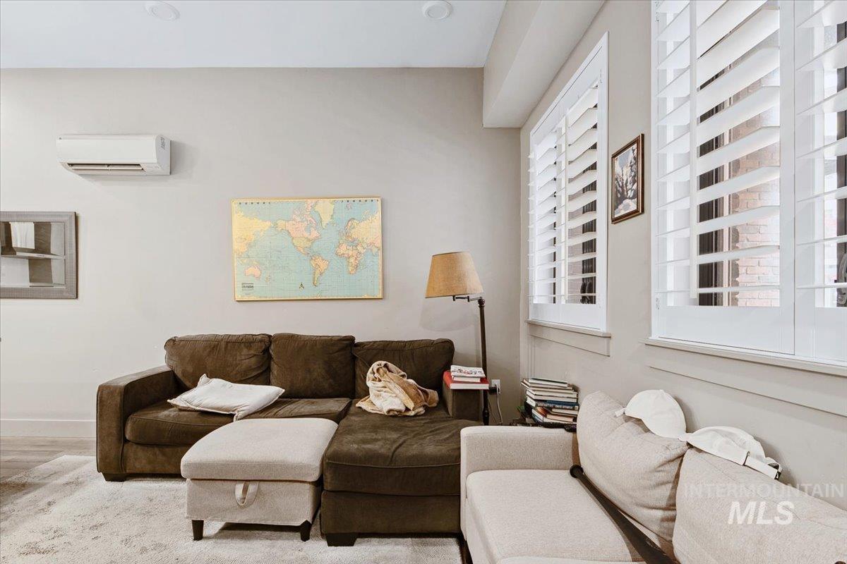 Living room featuring a mini split for heating / cooling and wood finished floors