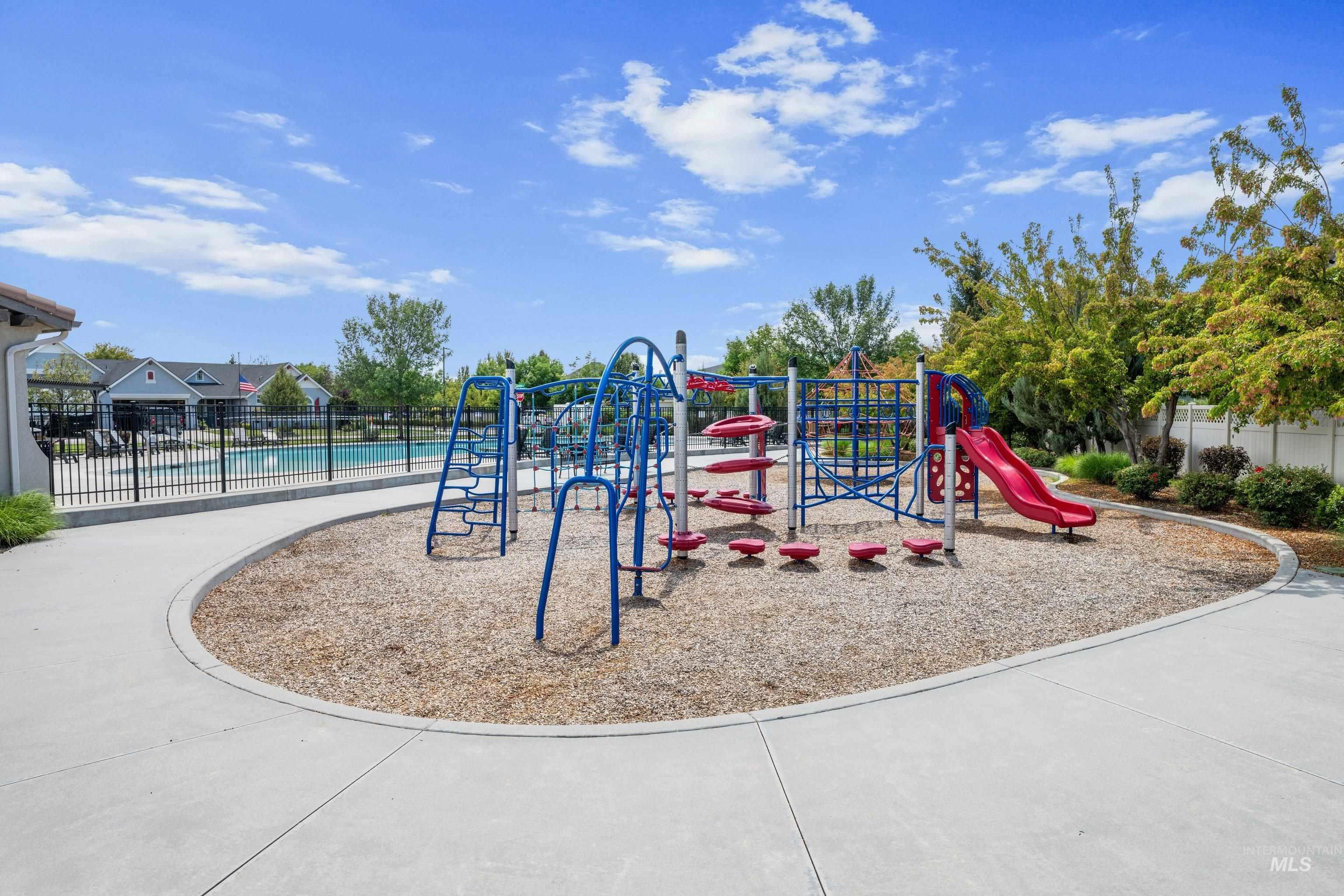 Community playground featuring a multi-level structure with slides and climbing elements