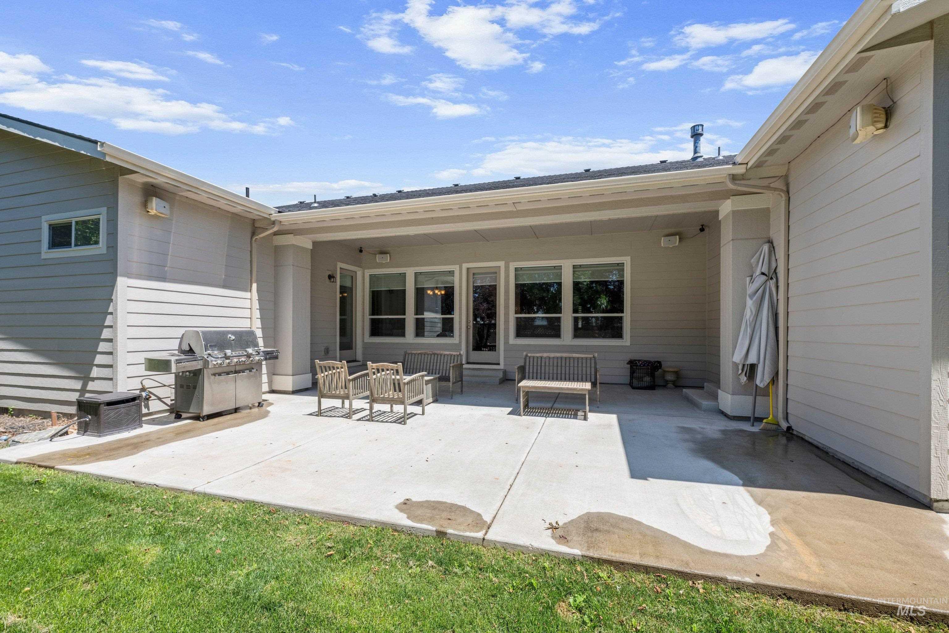 Expansive concrete patio offering direct outdoor access through multiple glass doors