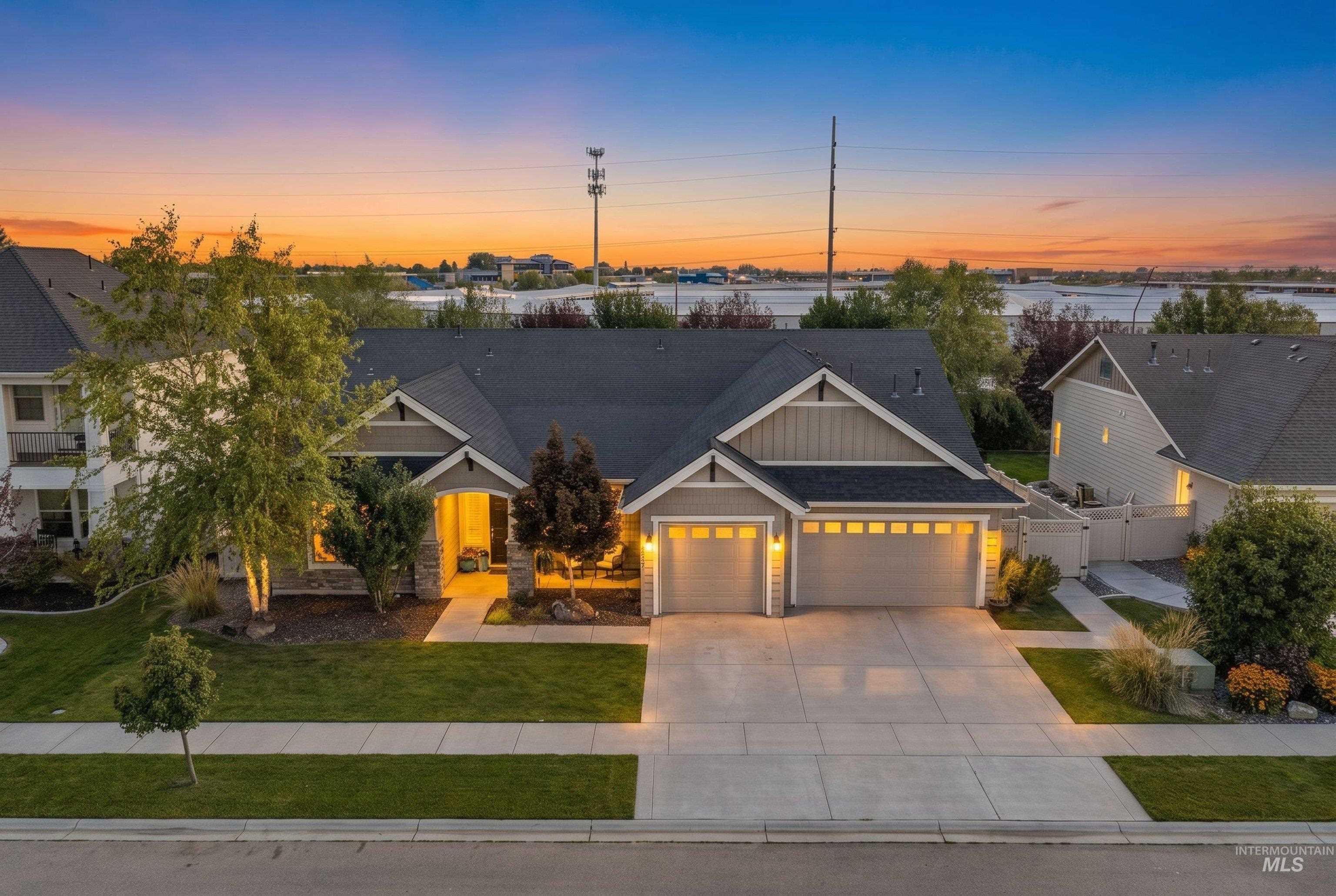 Contemporary-style residence featuring a two-car garage, concrete driveway, and a front entry with stone accents