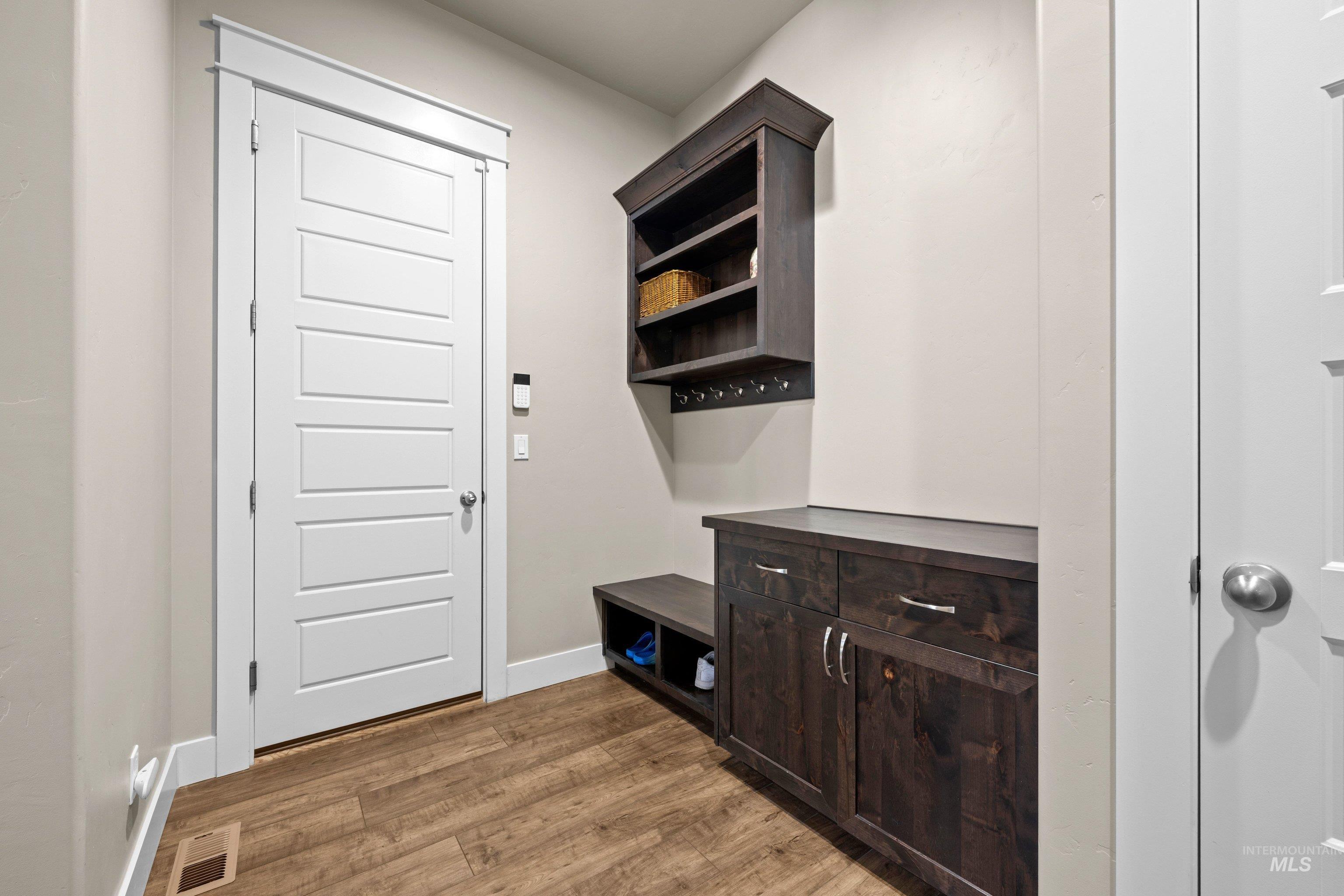 Entryway featuring wood-finish flooring and a five-panel interior door