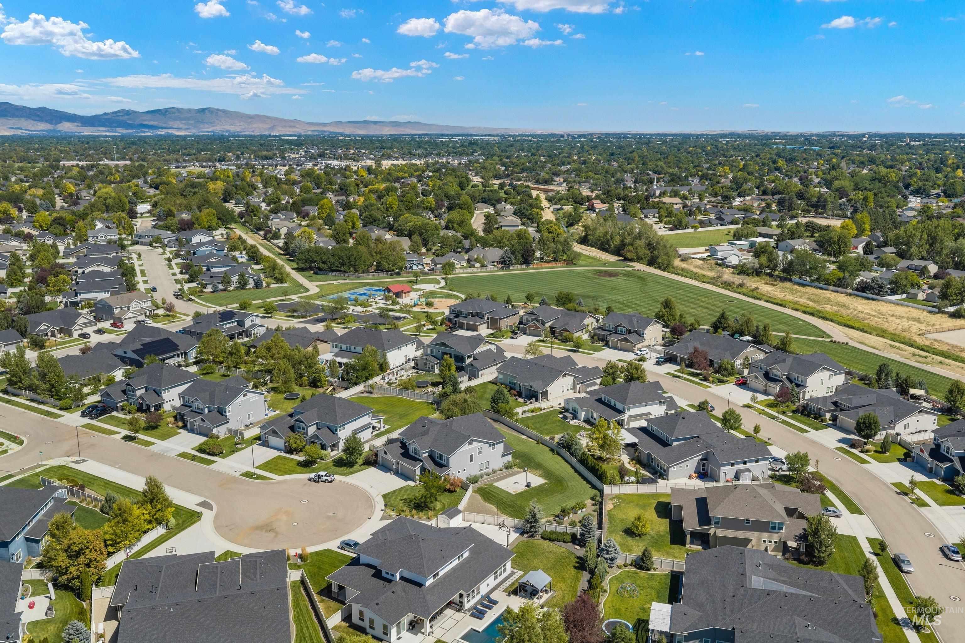 Aerial perspective of a developed residential neighborhood with varied architectural styles