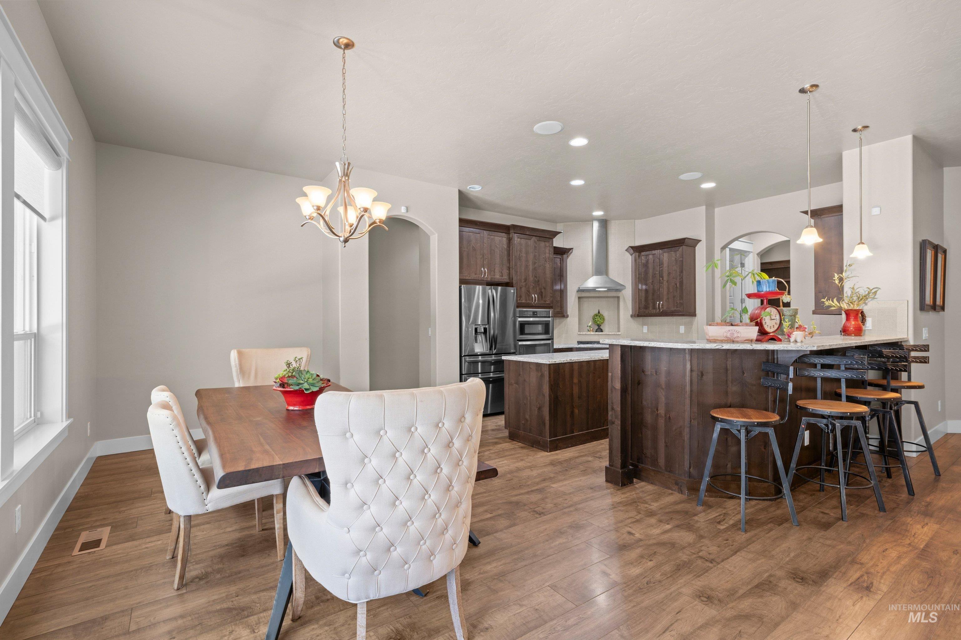 Open-concept kitchen and dining area featuring wood-finish flooring