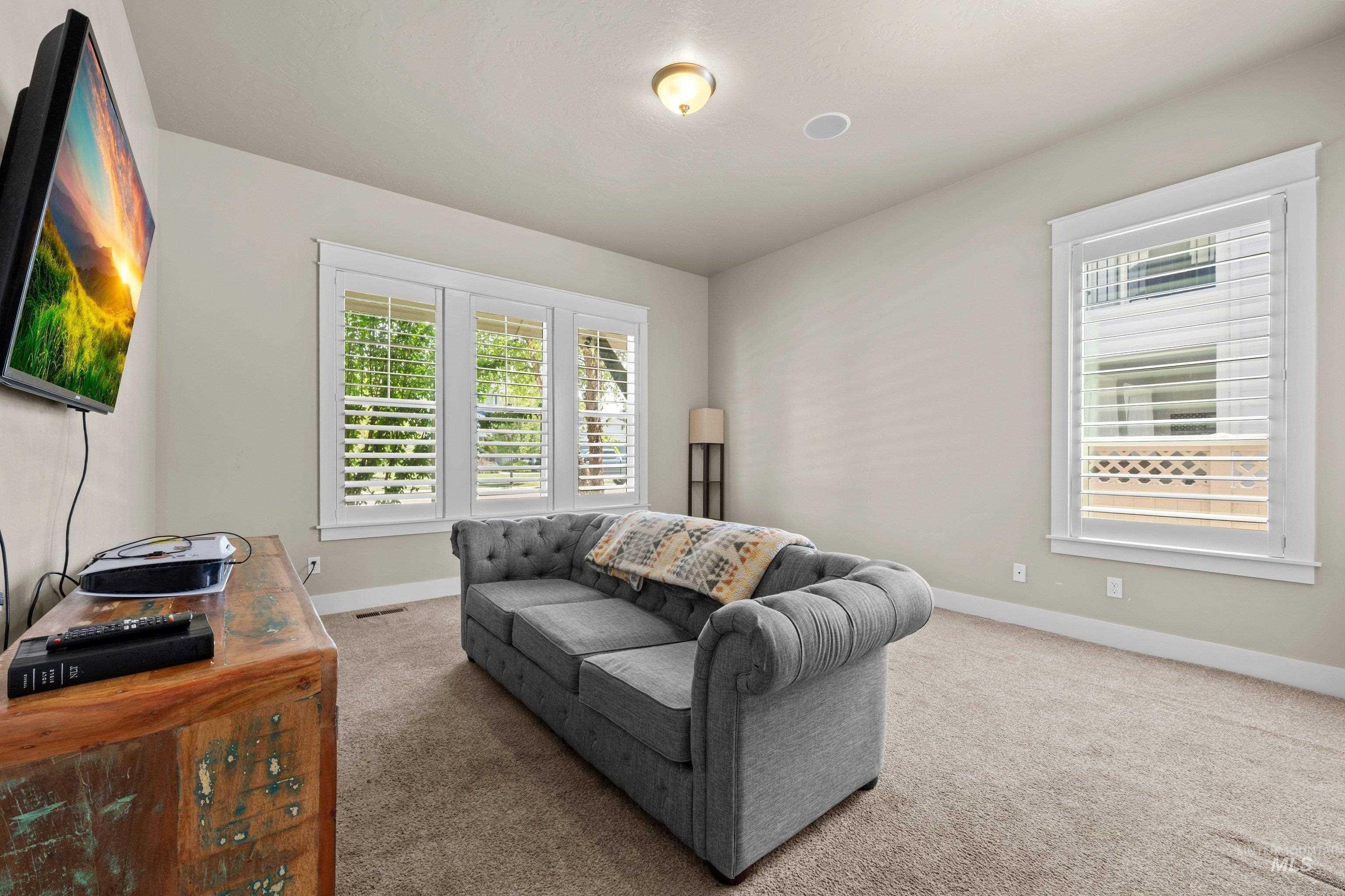 Carpeted interior space featuring light-toned walls and white trim