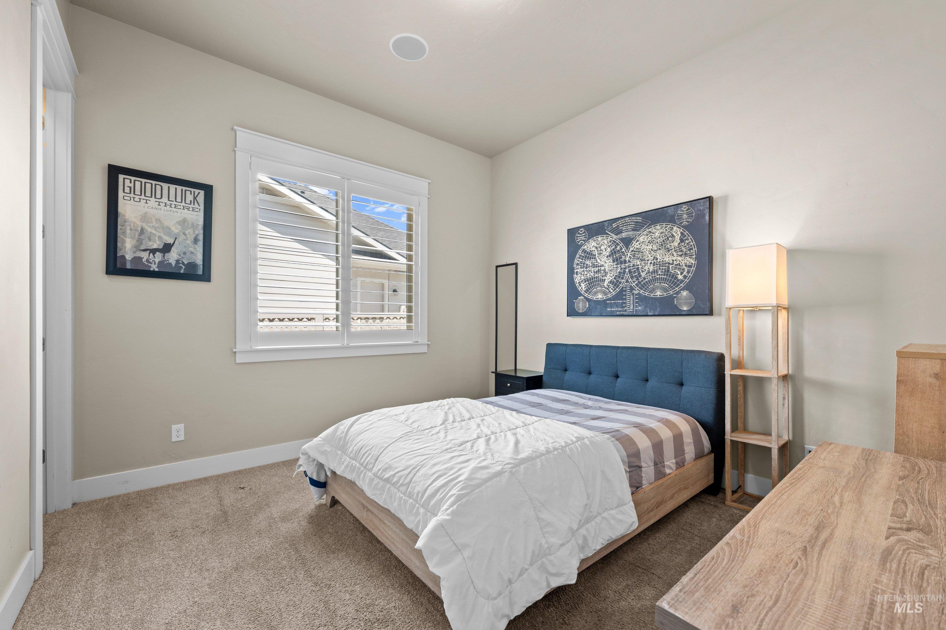 Neutral-toned walls and plush carpeting complement the white trim throughout this room