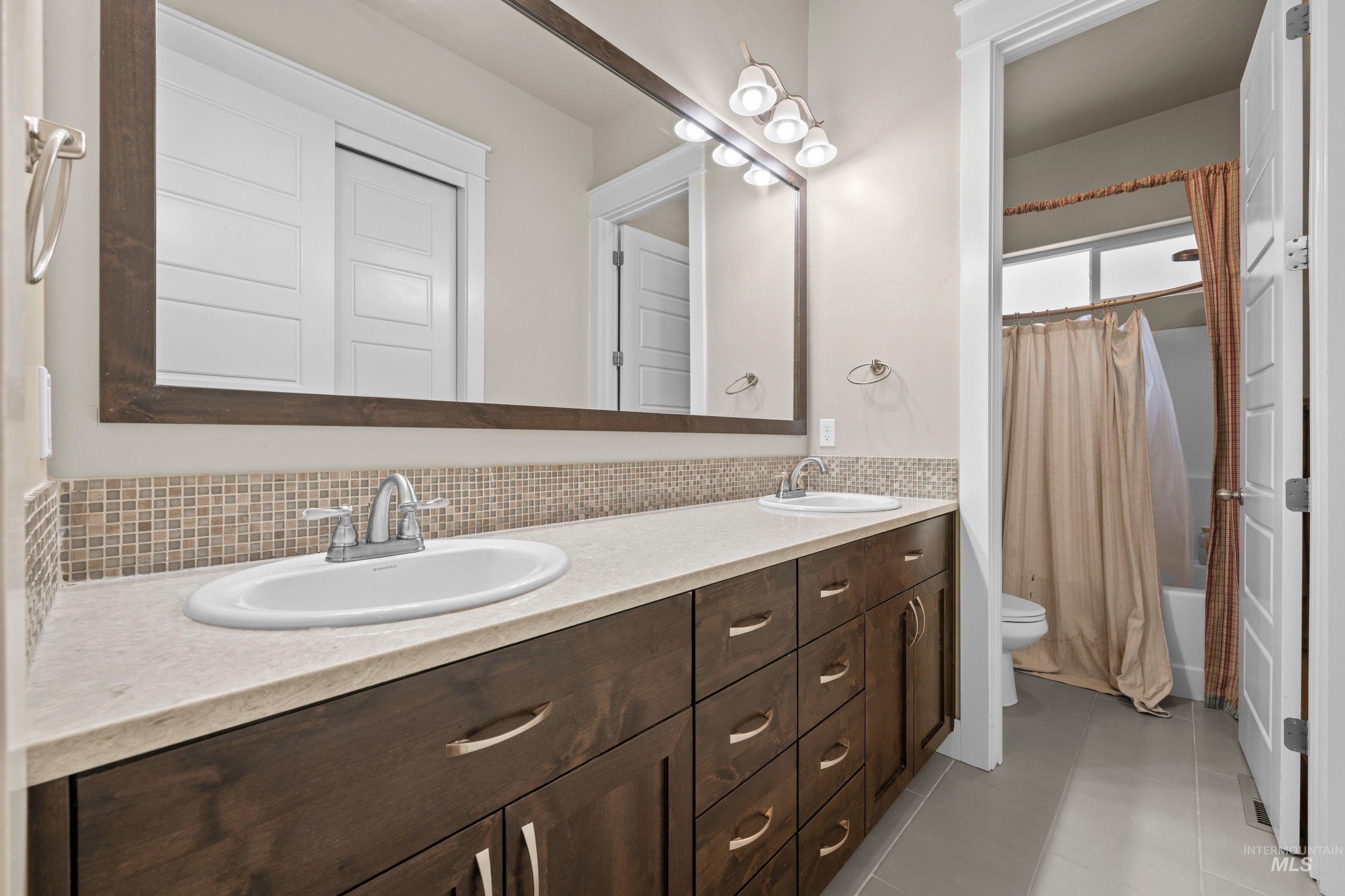 Dual vanity featuring recessed oval sinks and brushed nickel fixtures