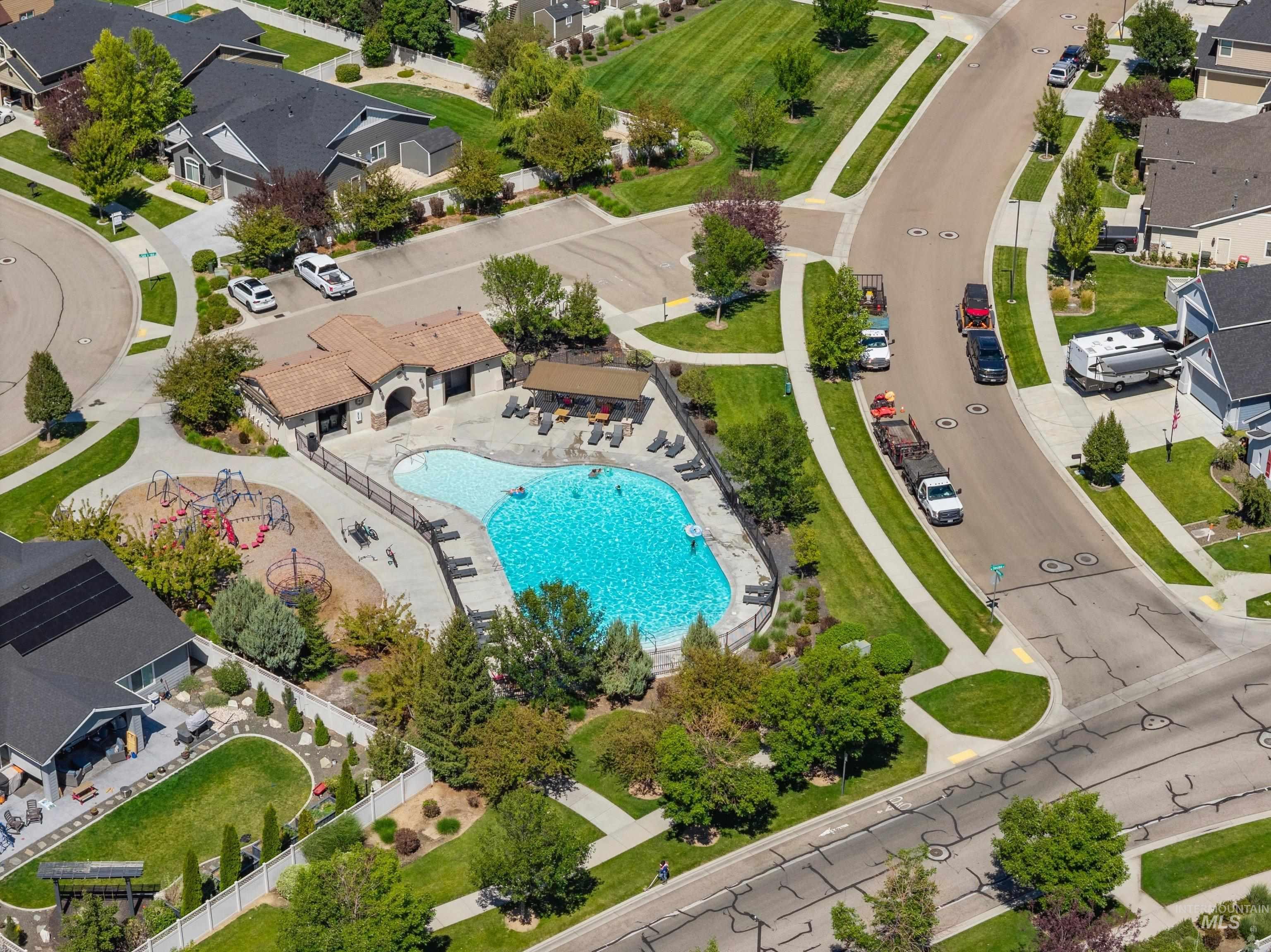 Community amenities featuring a large resort-style swimming pool, clubhouse, and playground structure